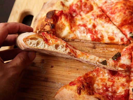 A slice of pizza that shows the side of the crust