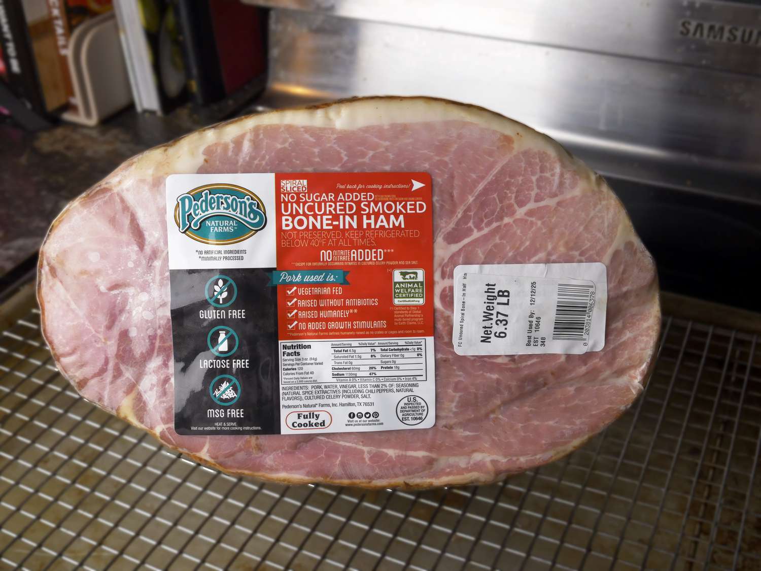 Pedersons ham wrapped and on a sheet tray