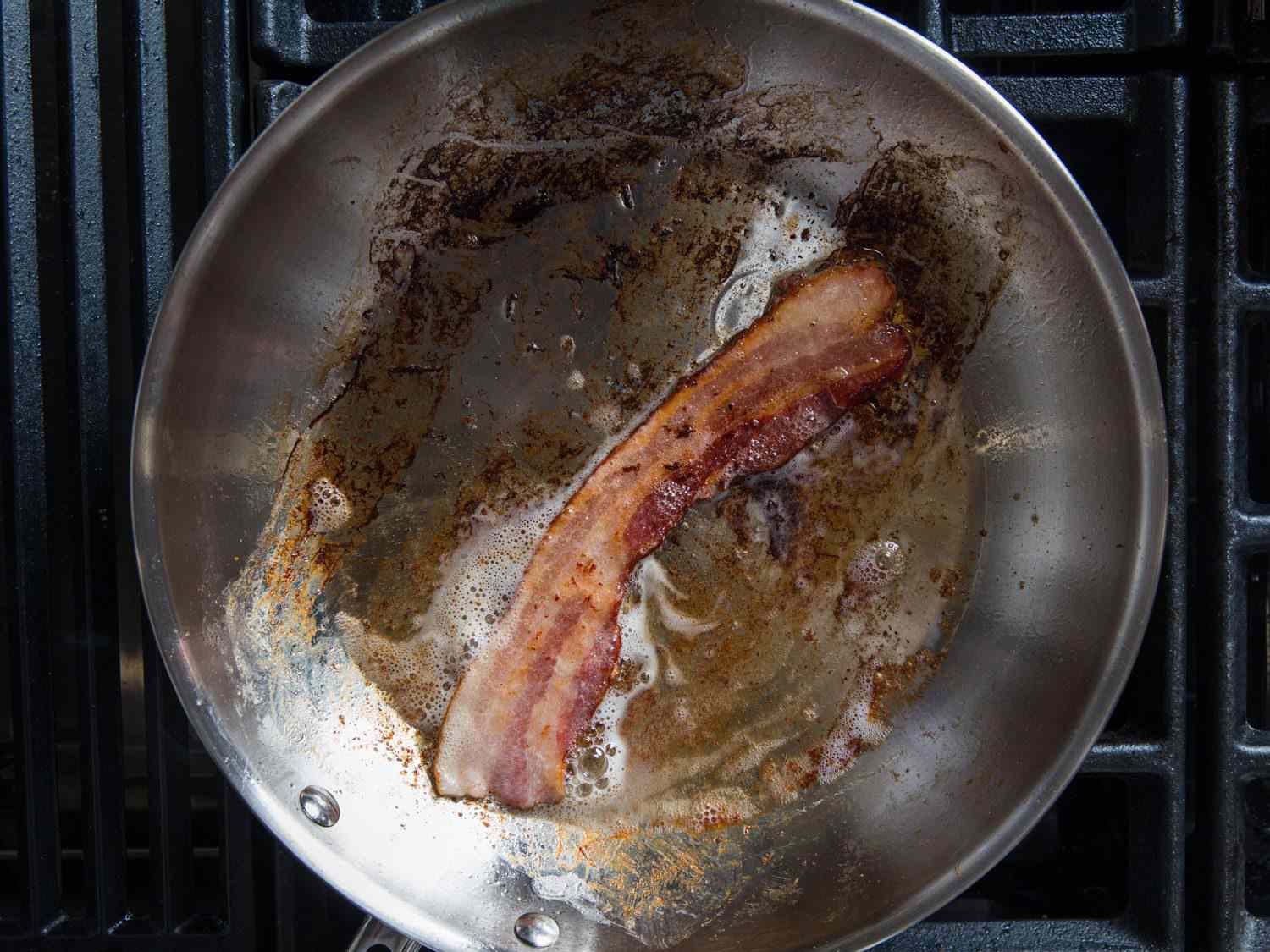 Cooking bacon in a stainless steel pan