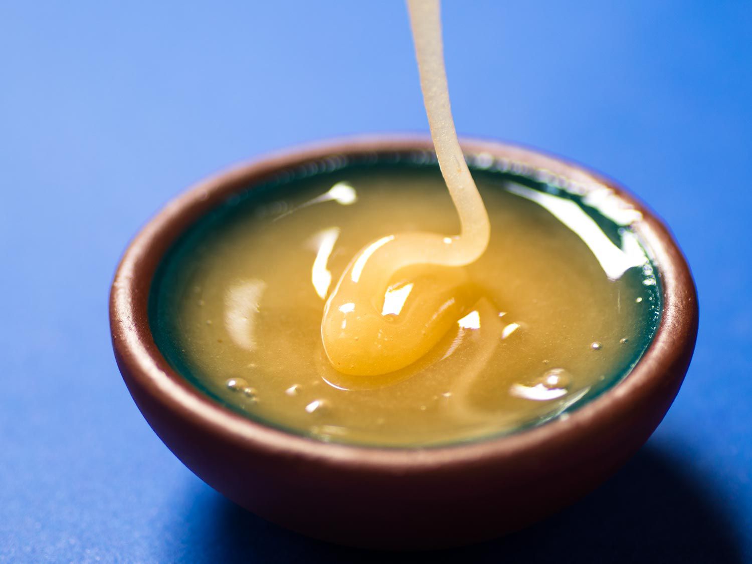 A small dish of raw unfiltered honey