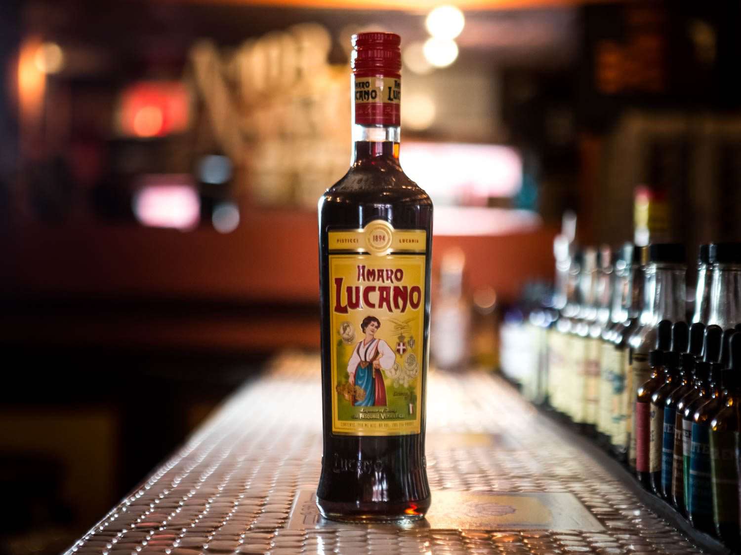 A bottle of Amaro Lucano on a bar counter. 