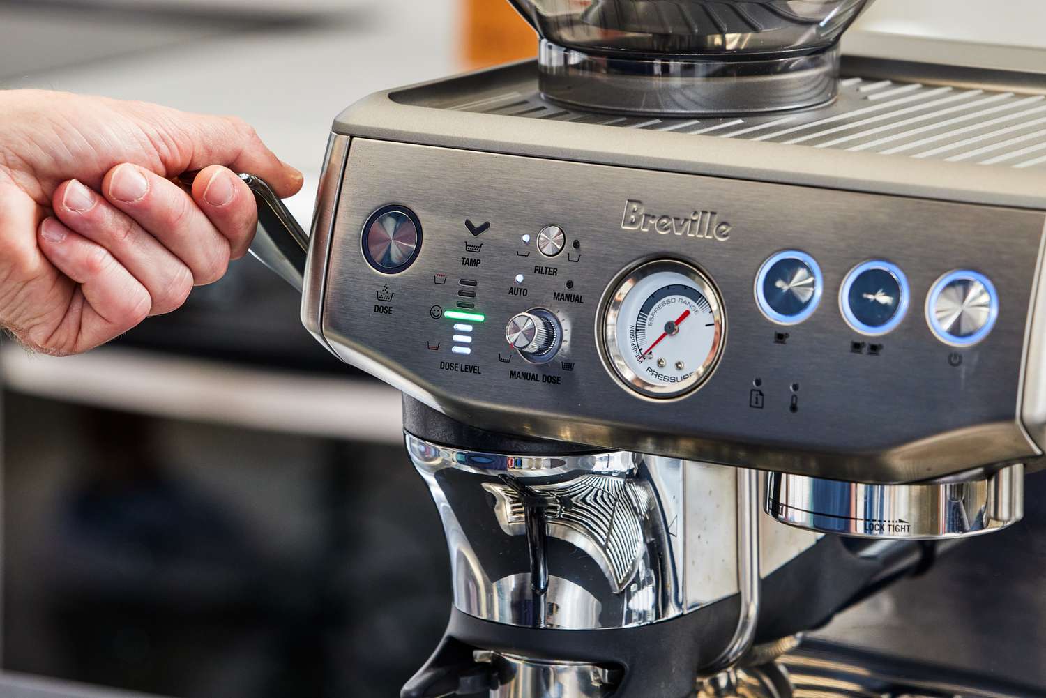 A person adjusting the Breville Barista Express Impress