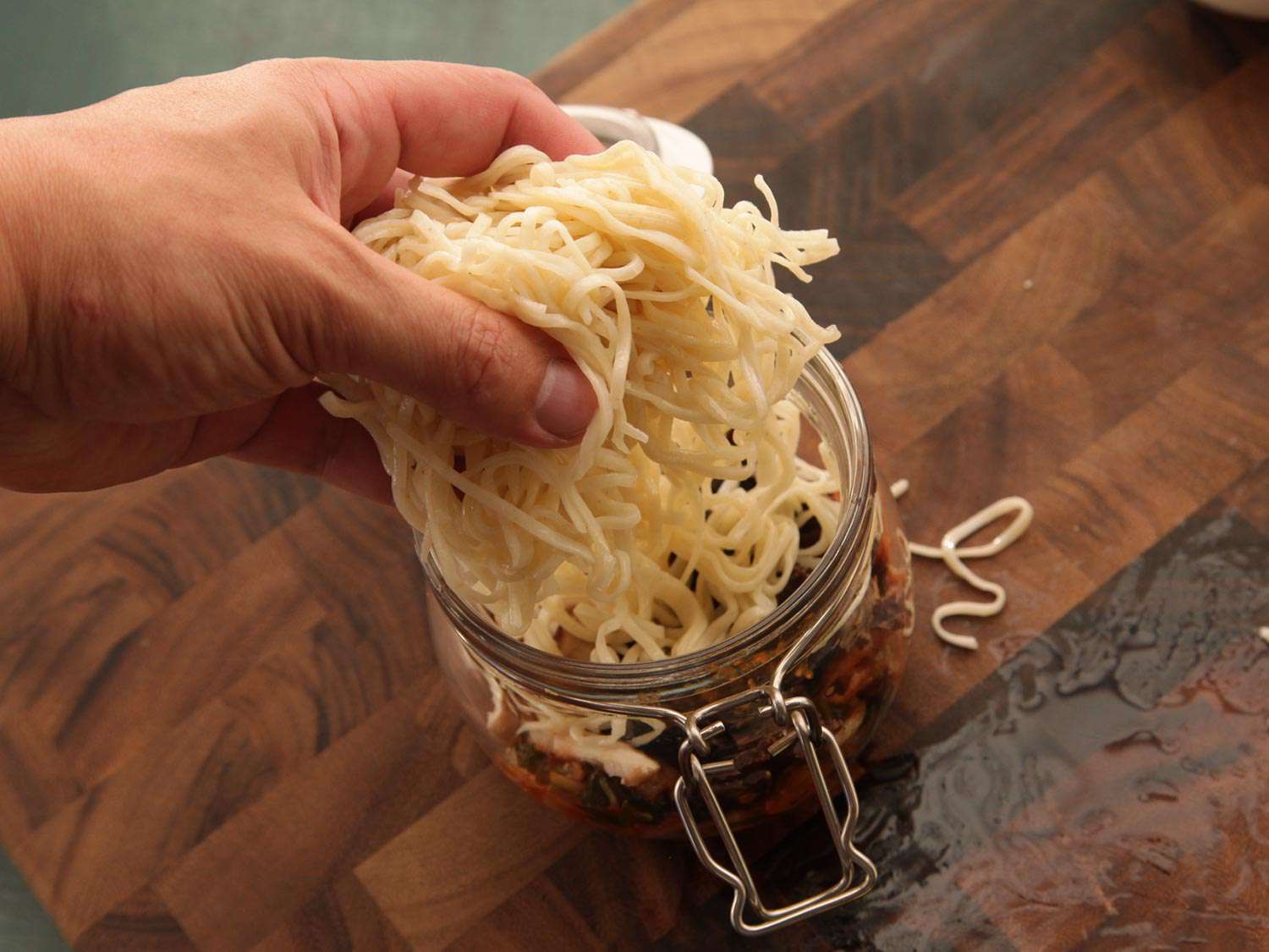 The noodles are added to the jar.
