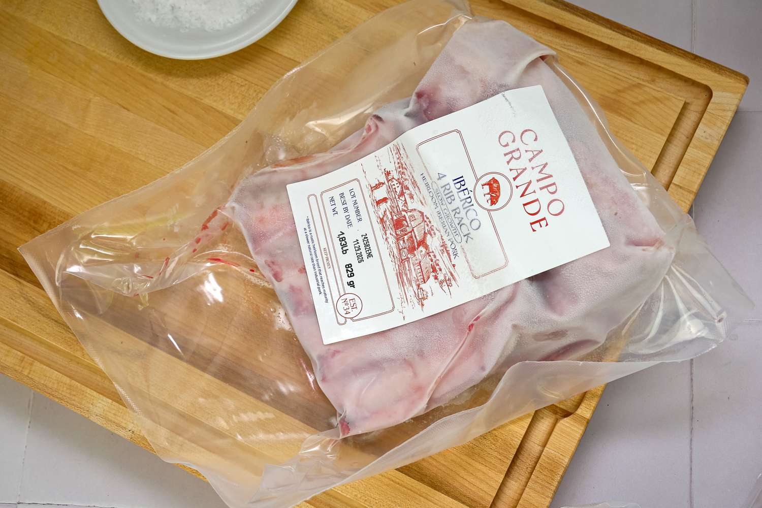Packaged meat labeled Campo Grande Iberico Rib Rack on a cutting board