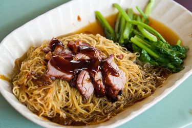 A white dish of wonton mee. 