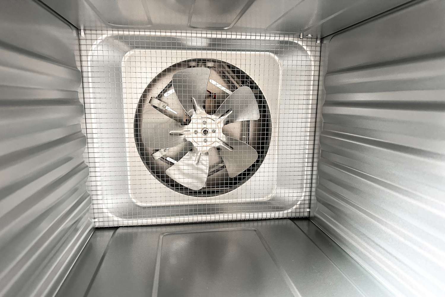 The inside of a food dehydrator with a fan in the back