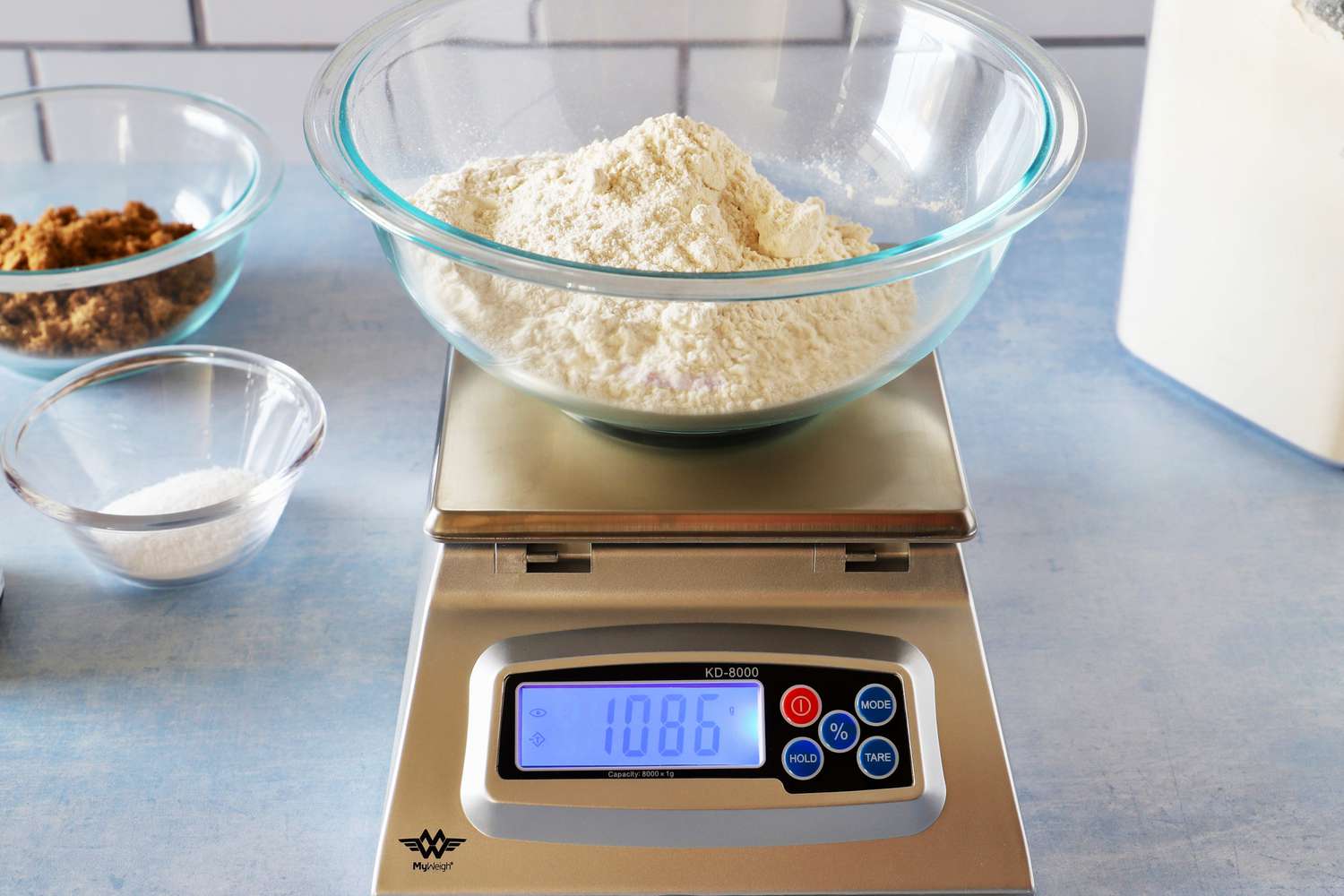 The My Weigh scale with a bowl of flour on top.