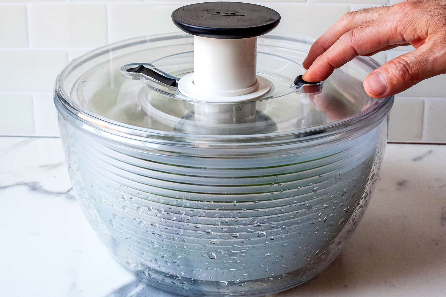 stopping the spinner on the oxo plastic salad spinner