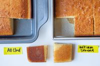 Two baking pans with sliced cake in them and beside them.