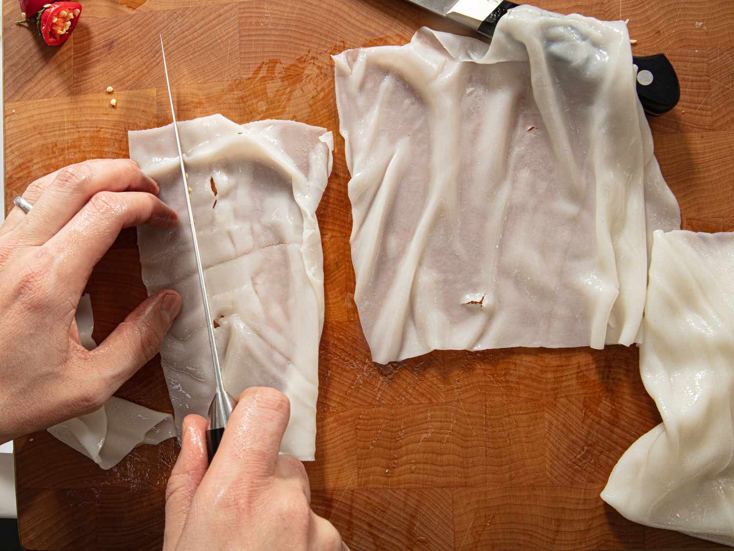 Overhead view of cutting fresh noodles