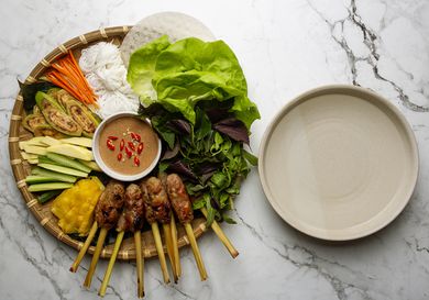 nem lui platter with a bowl of warm water alongside