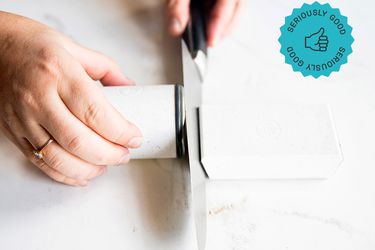 a person using the horl rolling knife sharpener to sharpen a chef's knife