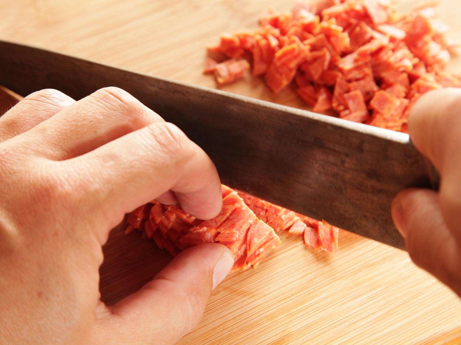 Finely dicing pepperoni for pepperoni garlic knots