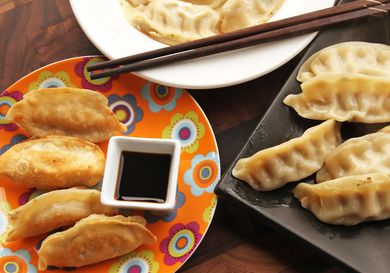Serving plate of fried and steamed dumplings.