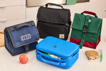 Four lunch boxes on a counter