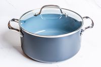 A pot from the GreenPan Valencia Pro Ceramic Nonstick 11-Piece Cookware Set on a white surface