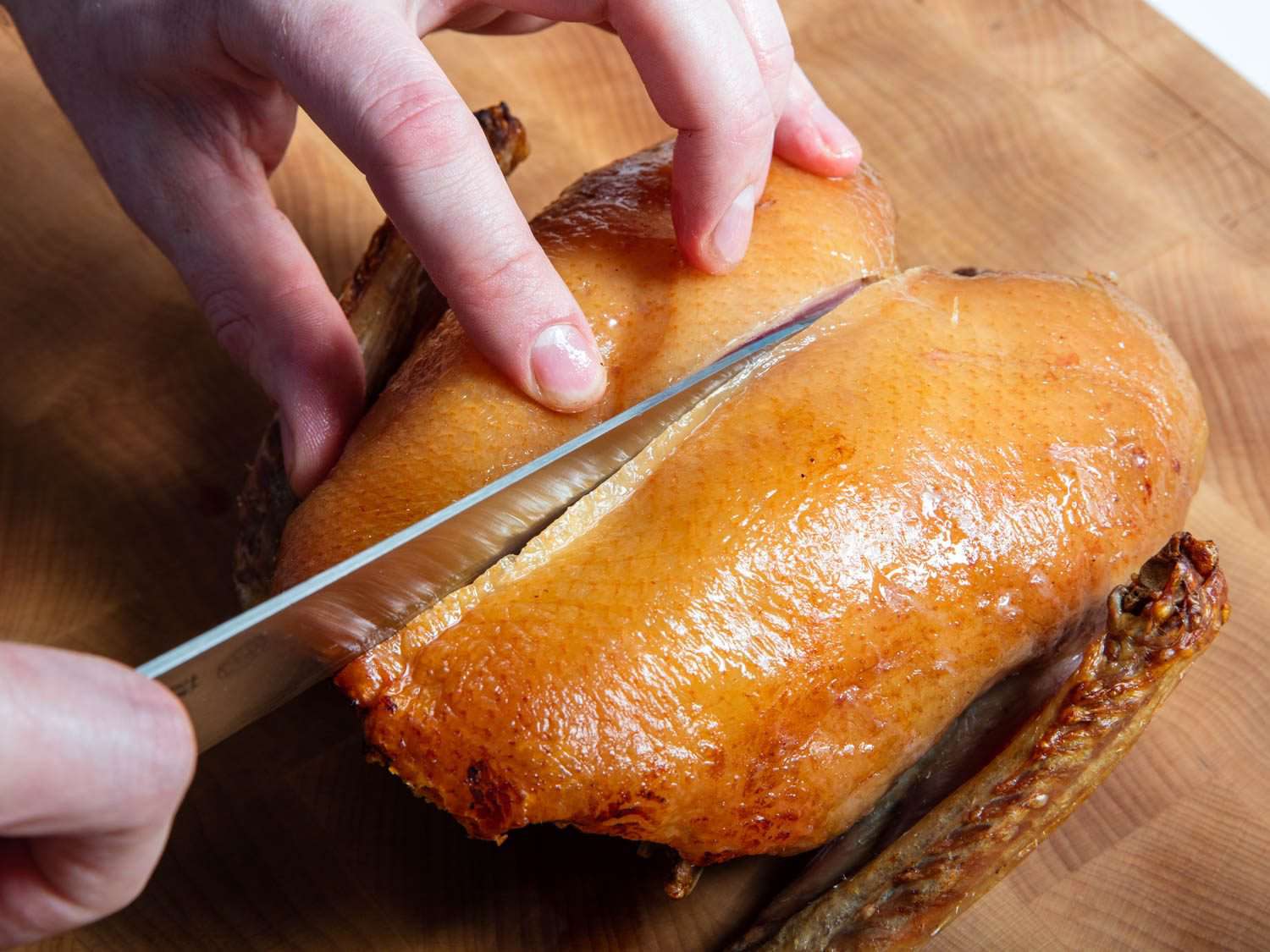 Slicing a duck breast off the crown.