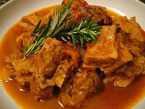 A dish of braised veal and peppers.