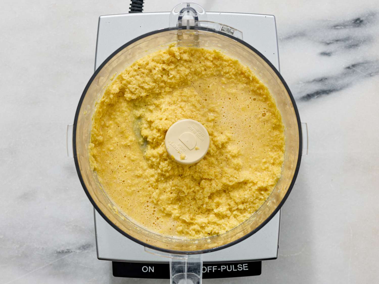Corn fritter batter being prepared in a food processor