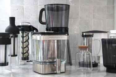 Numerous cold brew maker son a kitchen countertop.