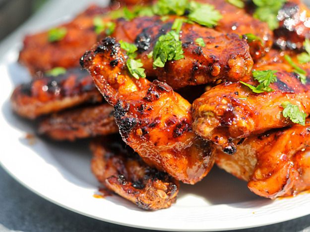 A close up of a pile of grilled honey chipotle wings.