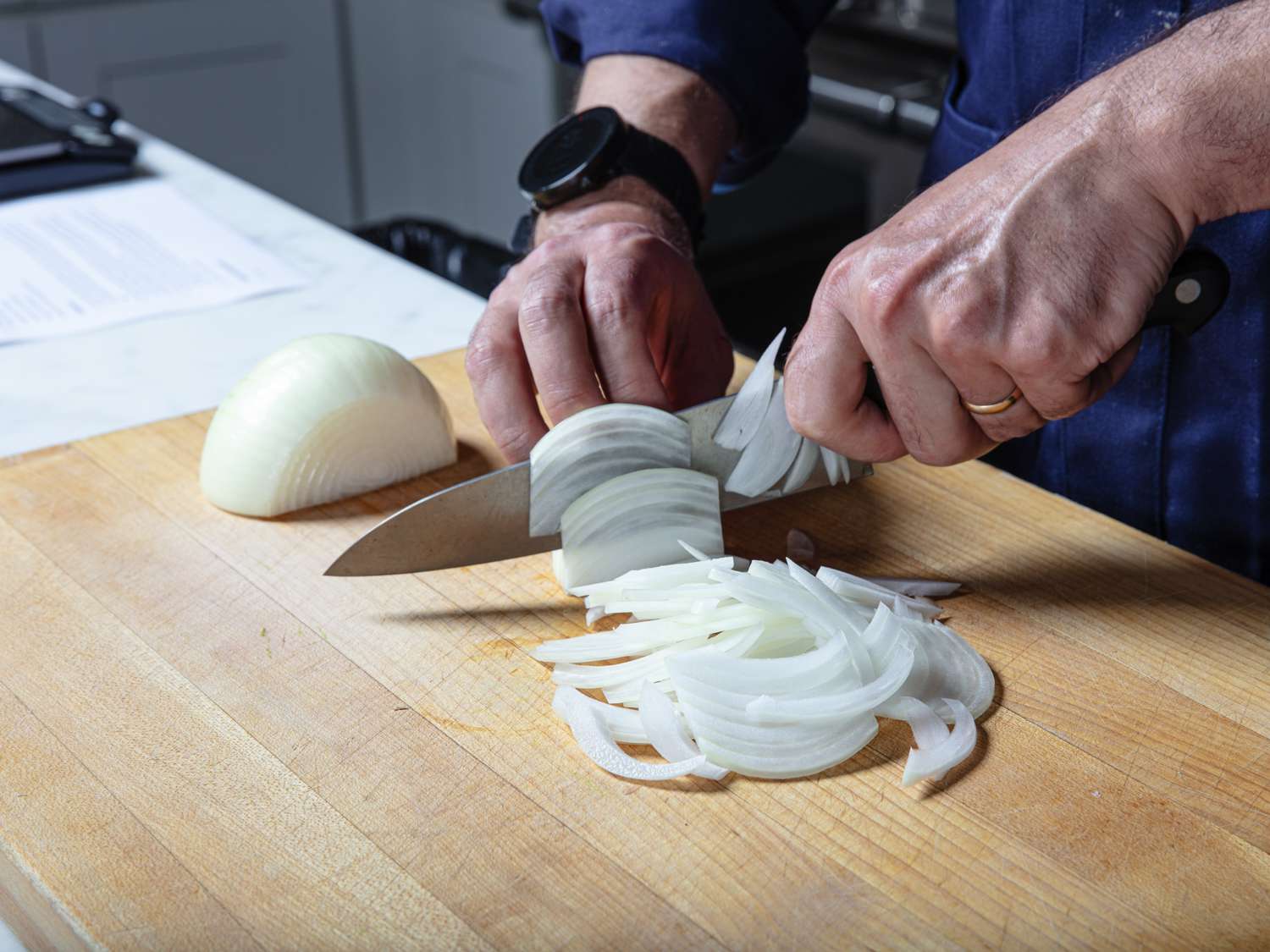 Slicing an onion pole to pole for cooking.