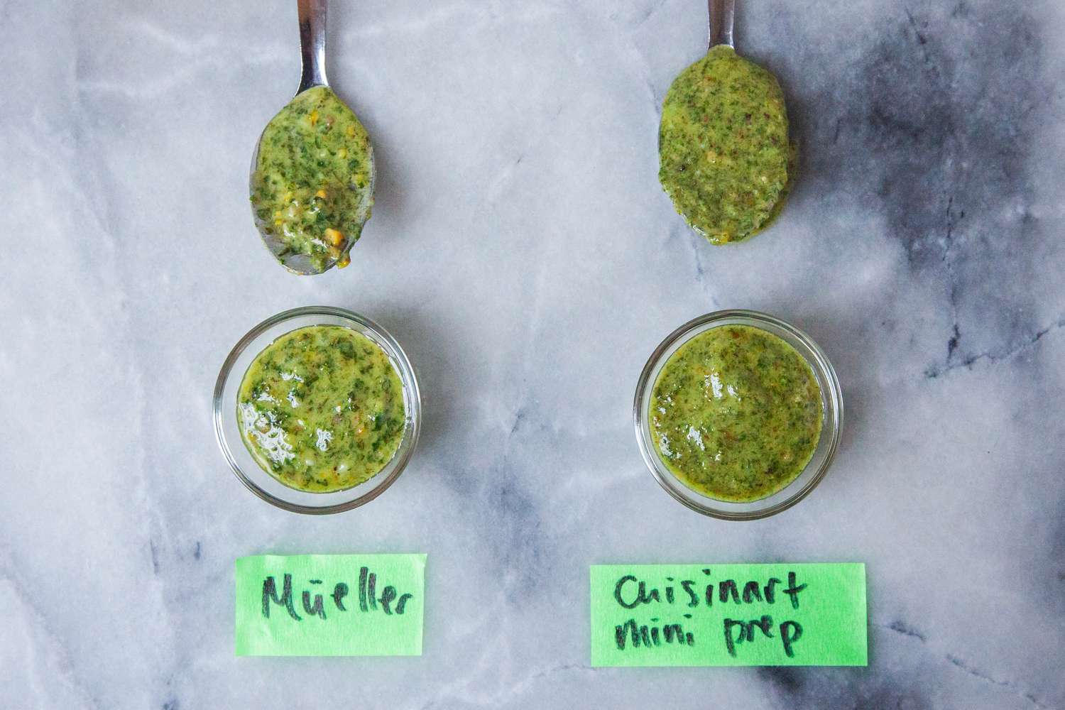 Two small bowls of pesto made in different mini food processors.