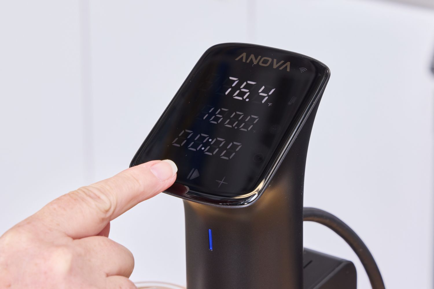 A person using the digital display on the Anova Precision Culinary Pro