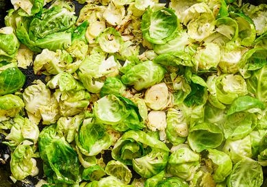 Cooked brussels sprouts sliced and arranged on a pan