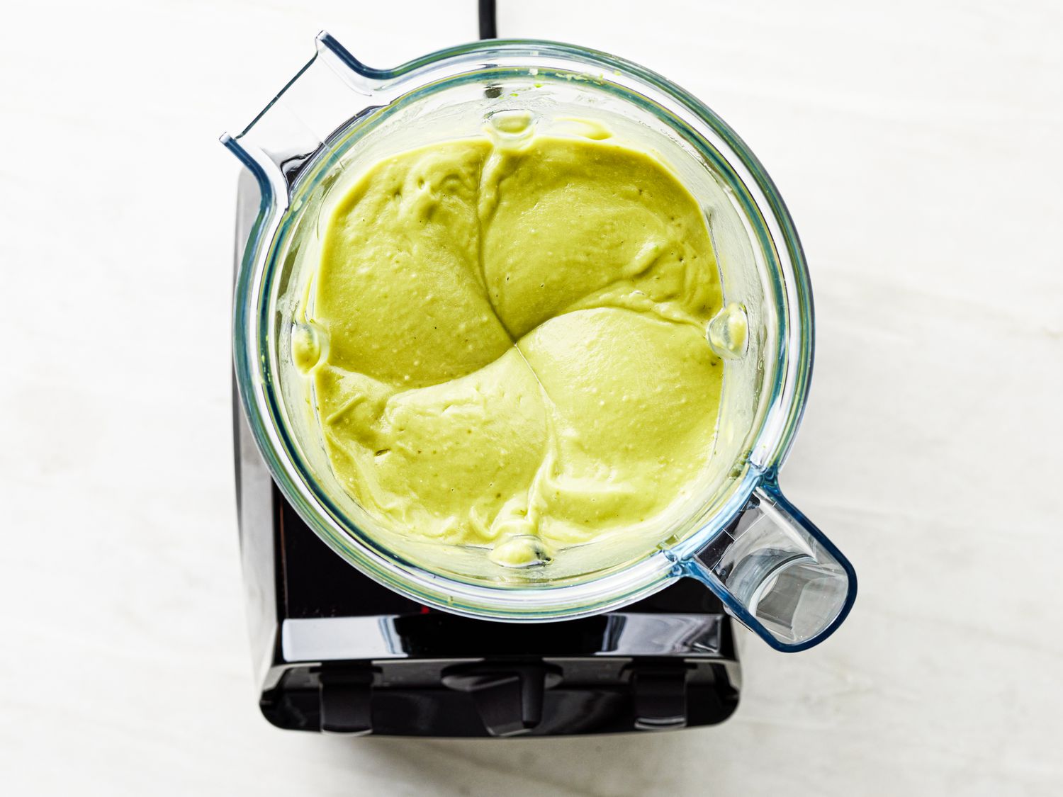 Overhead view of avocado ice cream mixture in a blender