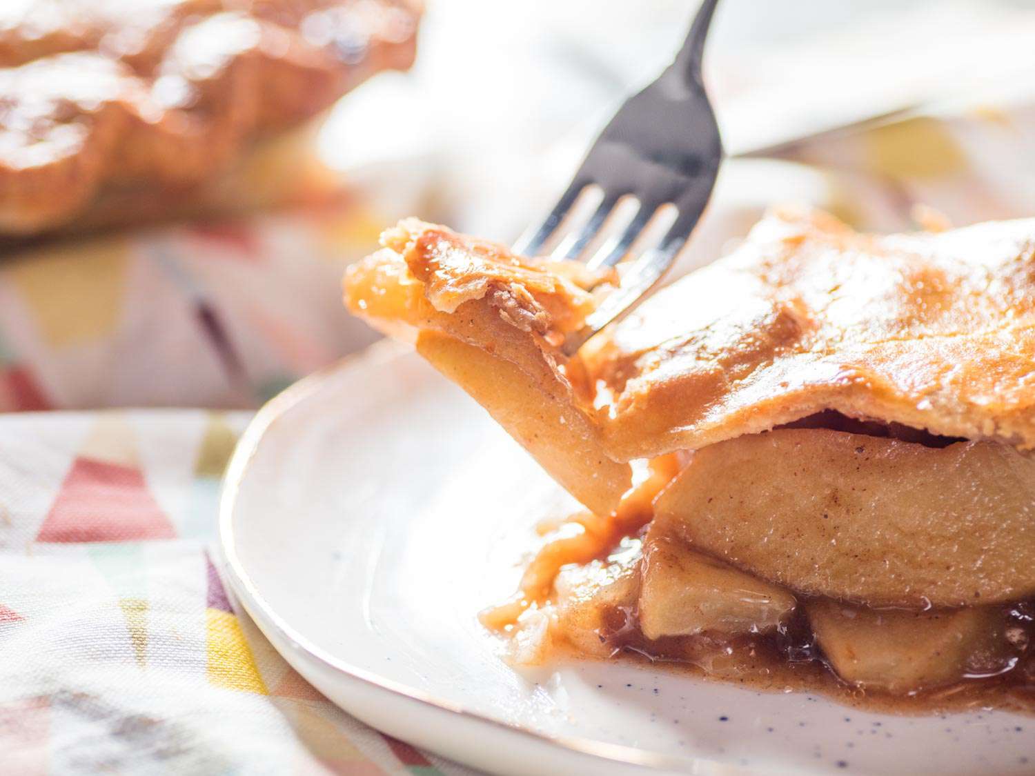 Eating a slice of pie with a fork.