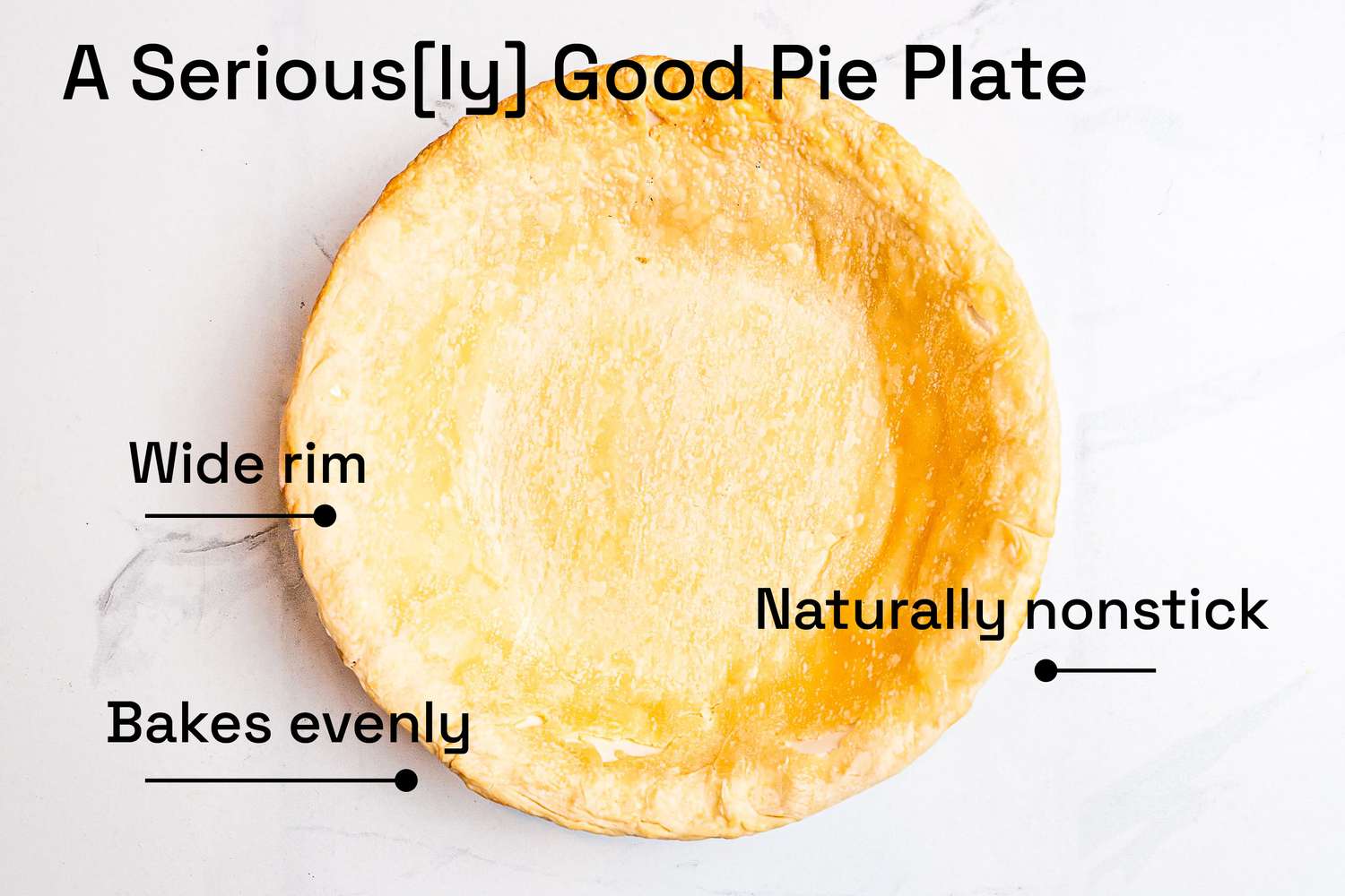 An overhead view of a baked pie crust on a white surface