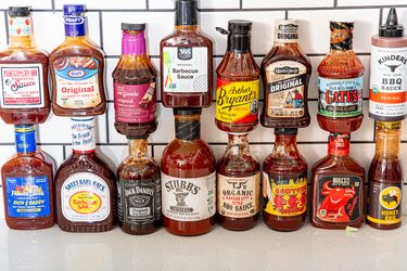 A selection of various barbecue sauce bottles arranged on a counter