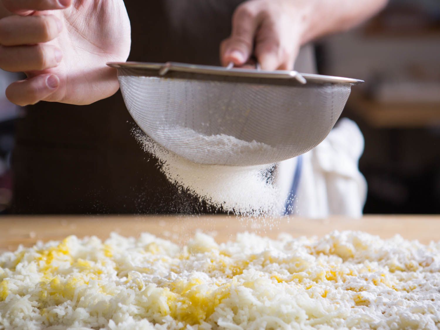 a strainer dusting flour