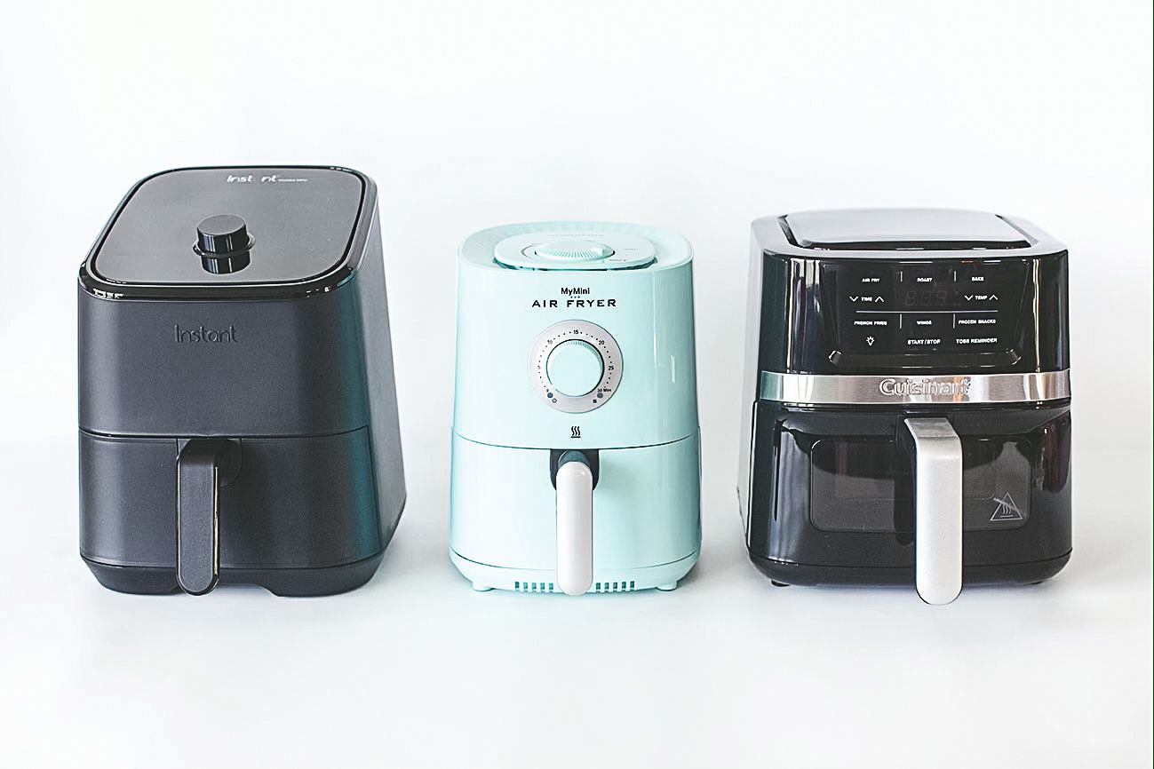 Three air fryers of different brands are displayed