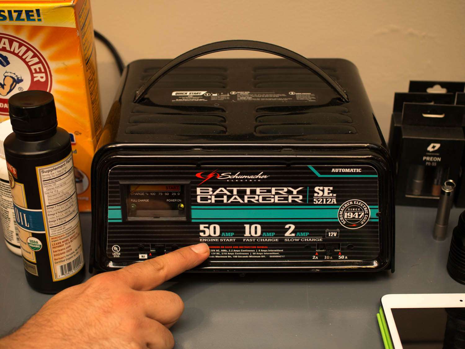 A car battery charger resting on a counter.