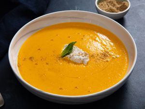 A bowl of chilled minty carrot soup with dukkah yogurt.