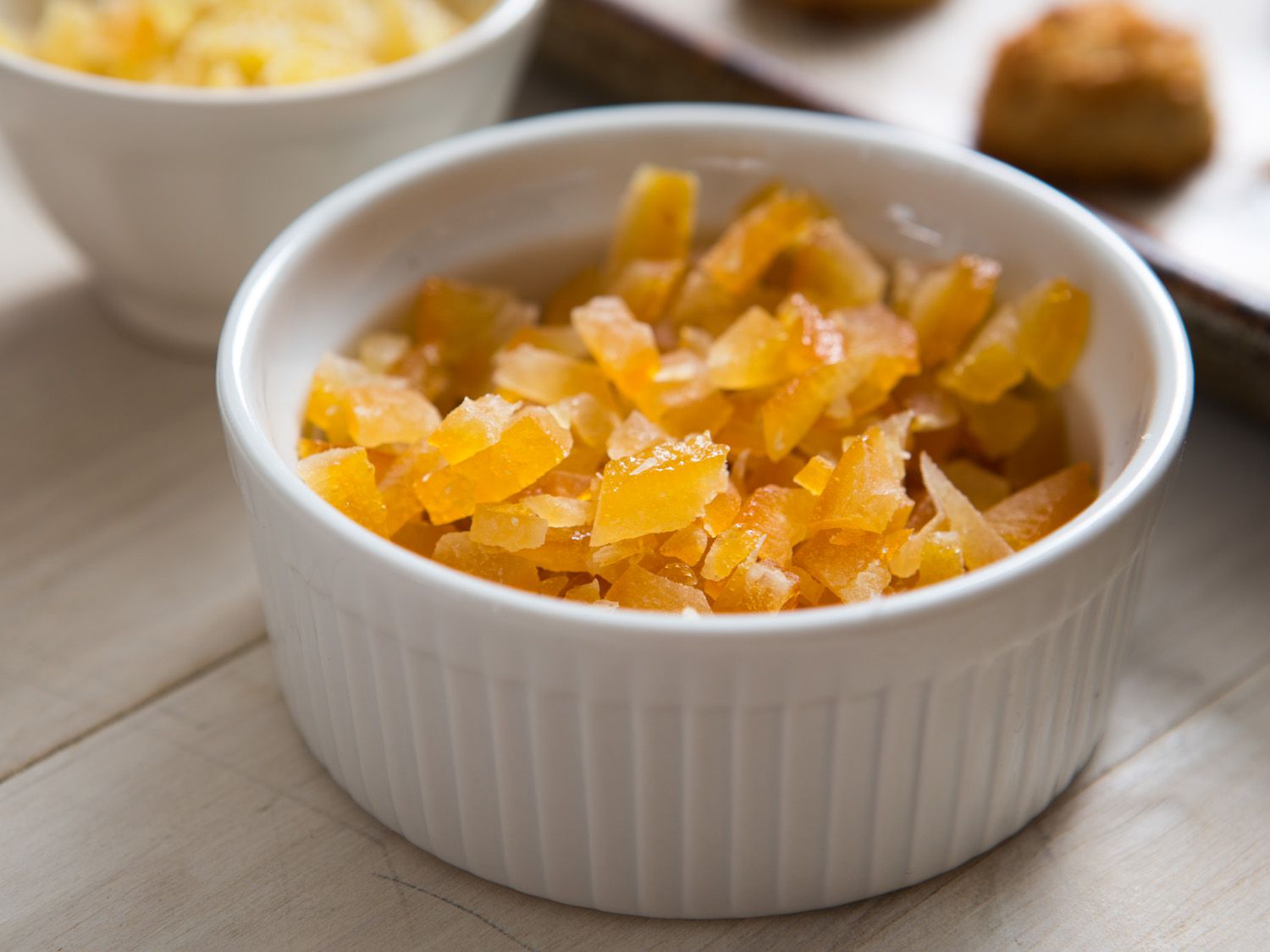 A ramekin of candied orange peel resting on a table
