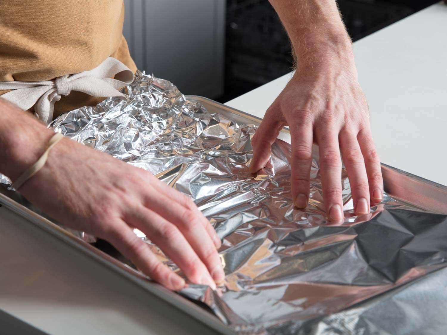 Preparing foil-lined baking sheet for oysters