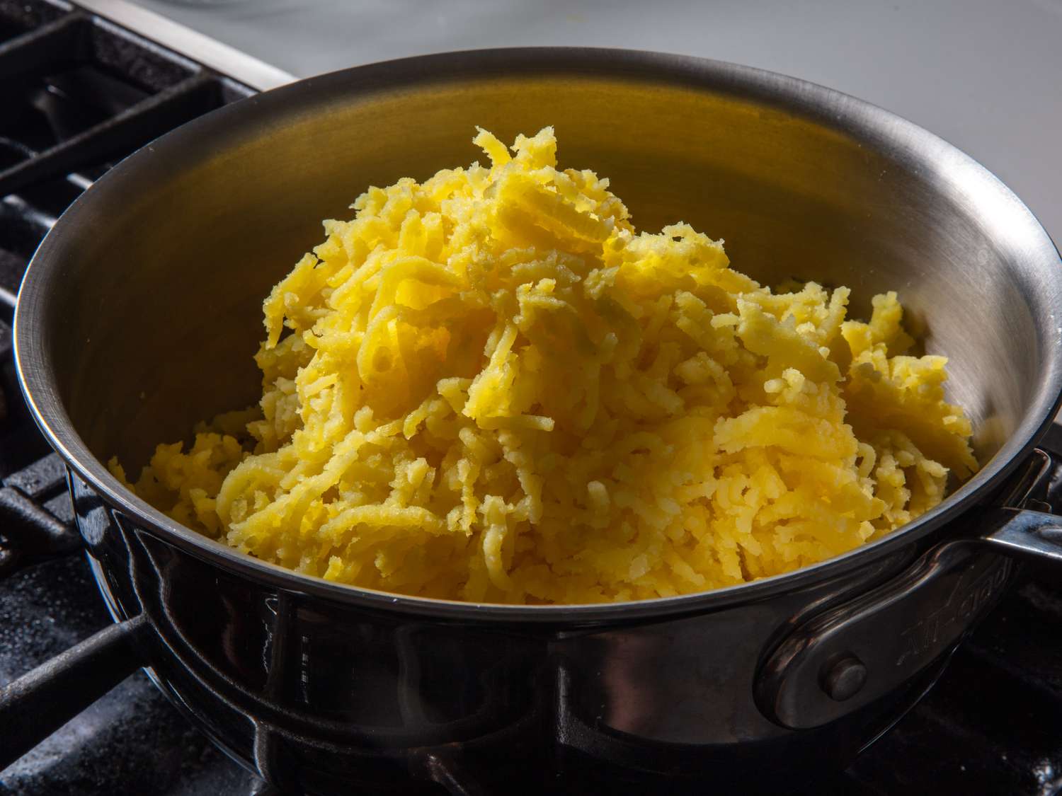 Riced Yukon Gold potatoes in a pot on the stovetop.