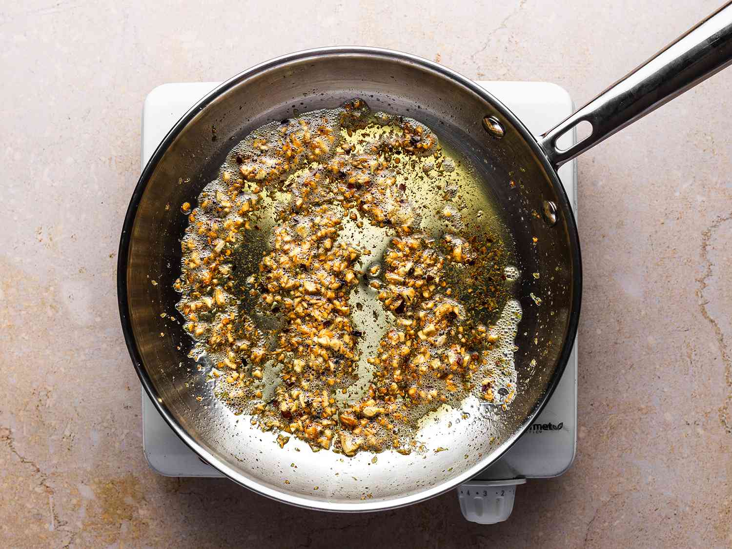 Garlic butter in a sauce pan for roasted-garlic no-knead foccacia.