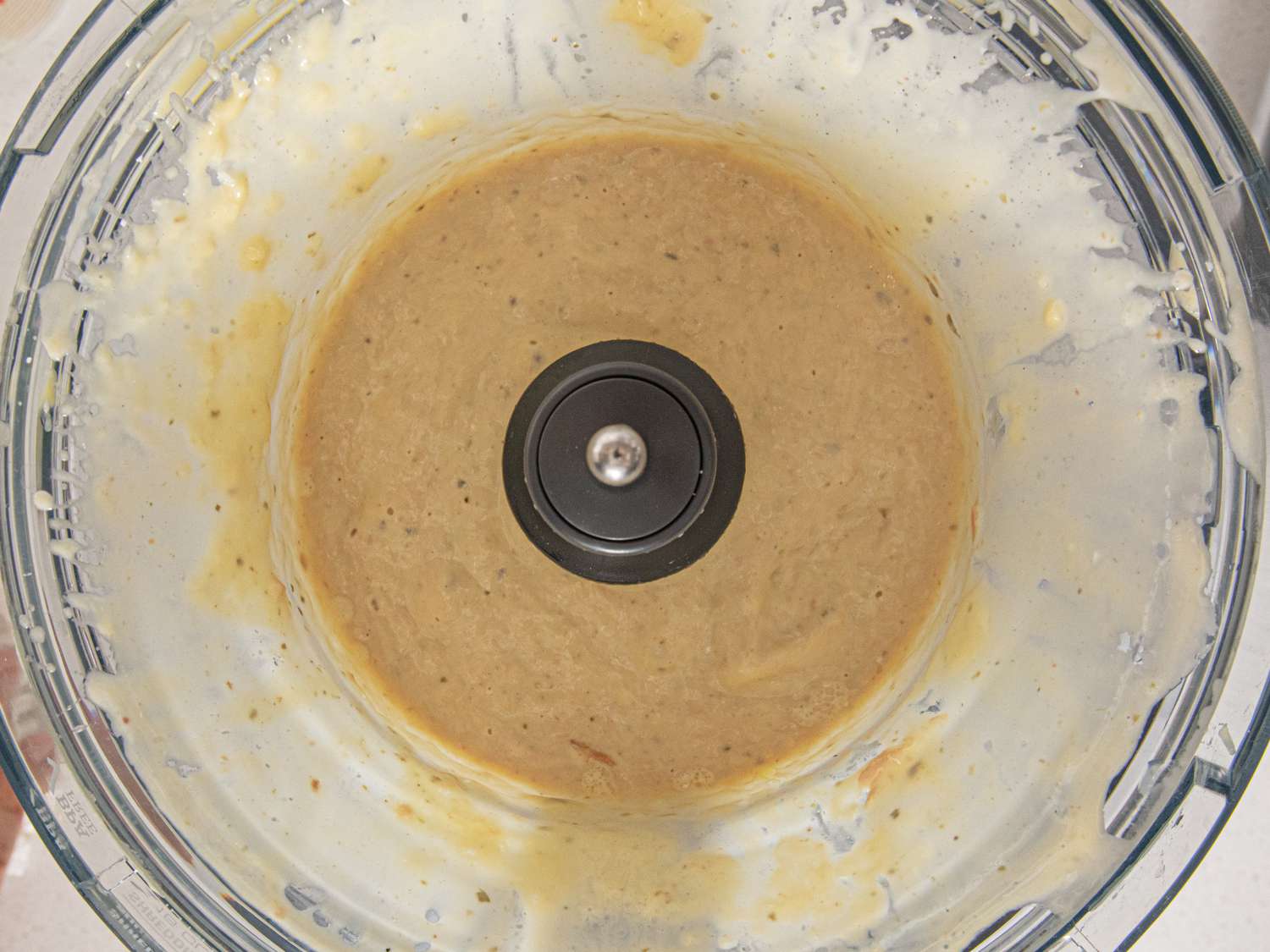 Blended sauce in a food processor, showing smooth texture