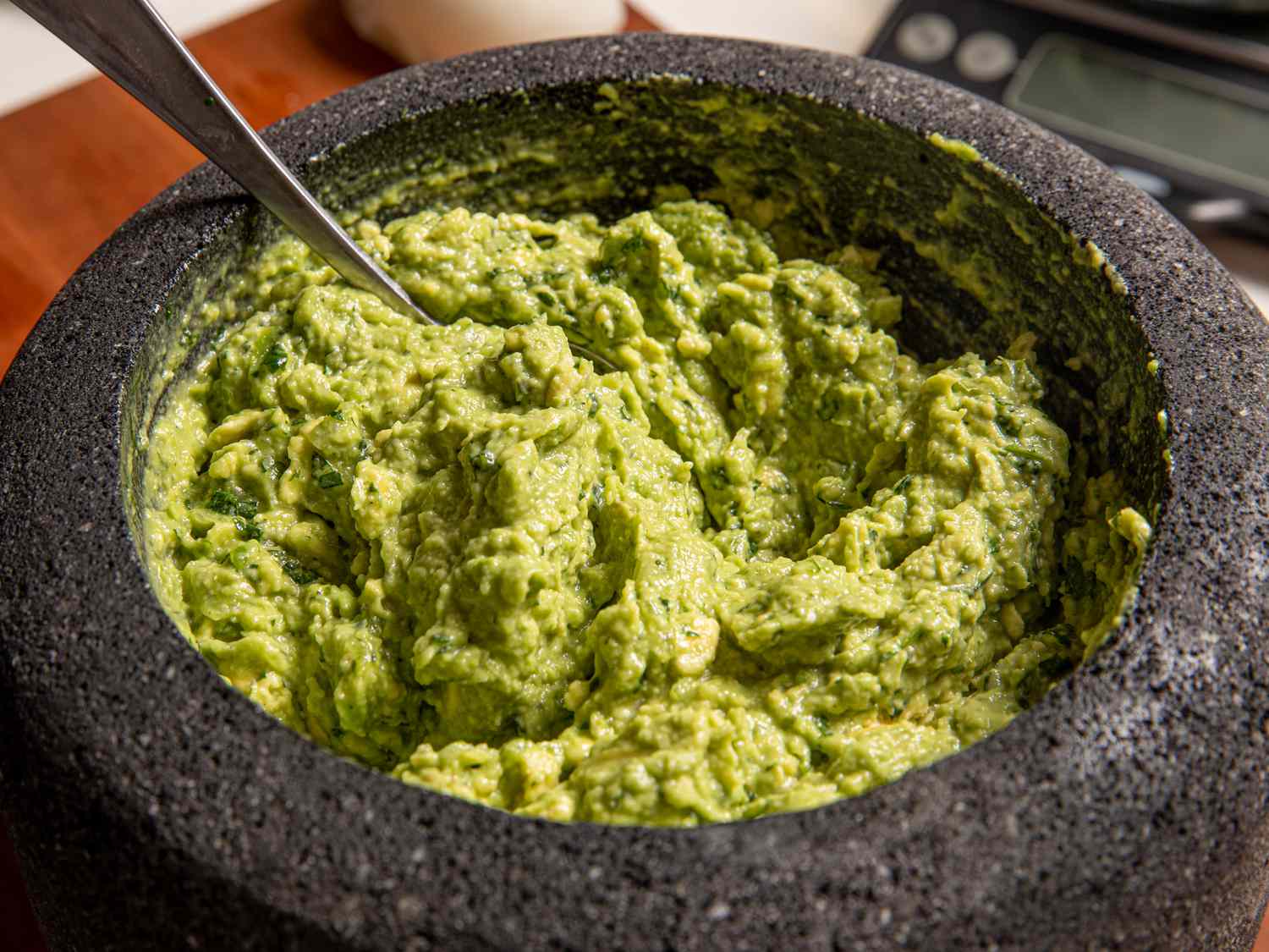 Side angle view of guacamole in a molcajete