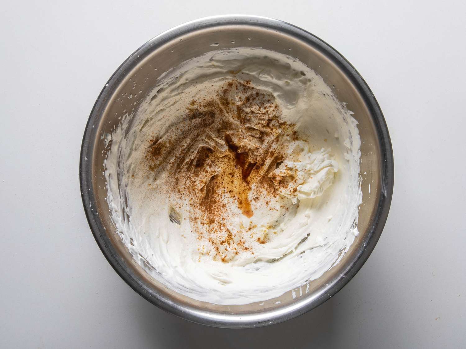 Whipped cream and creme fraiche with spices in a bowl