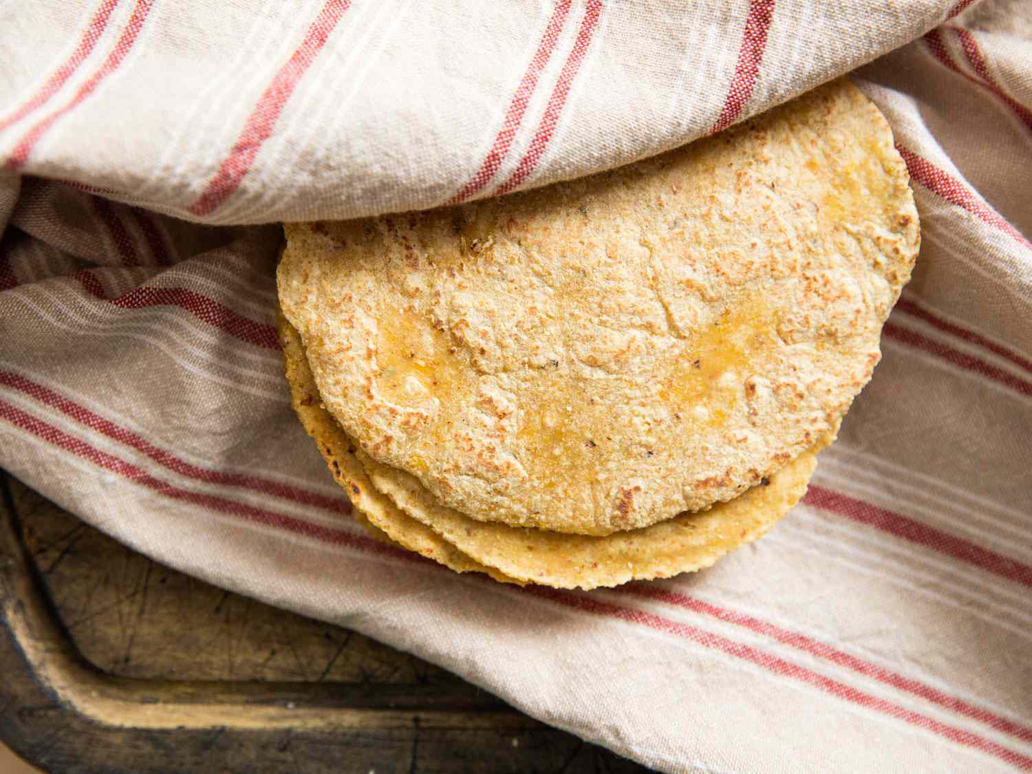A stack of freshly-made homemade corn tortillas