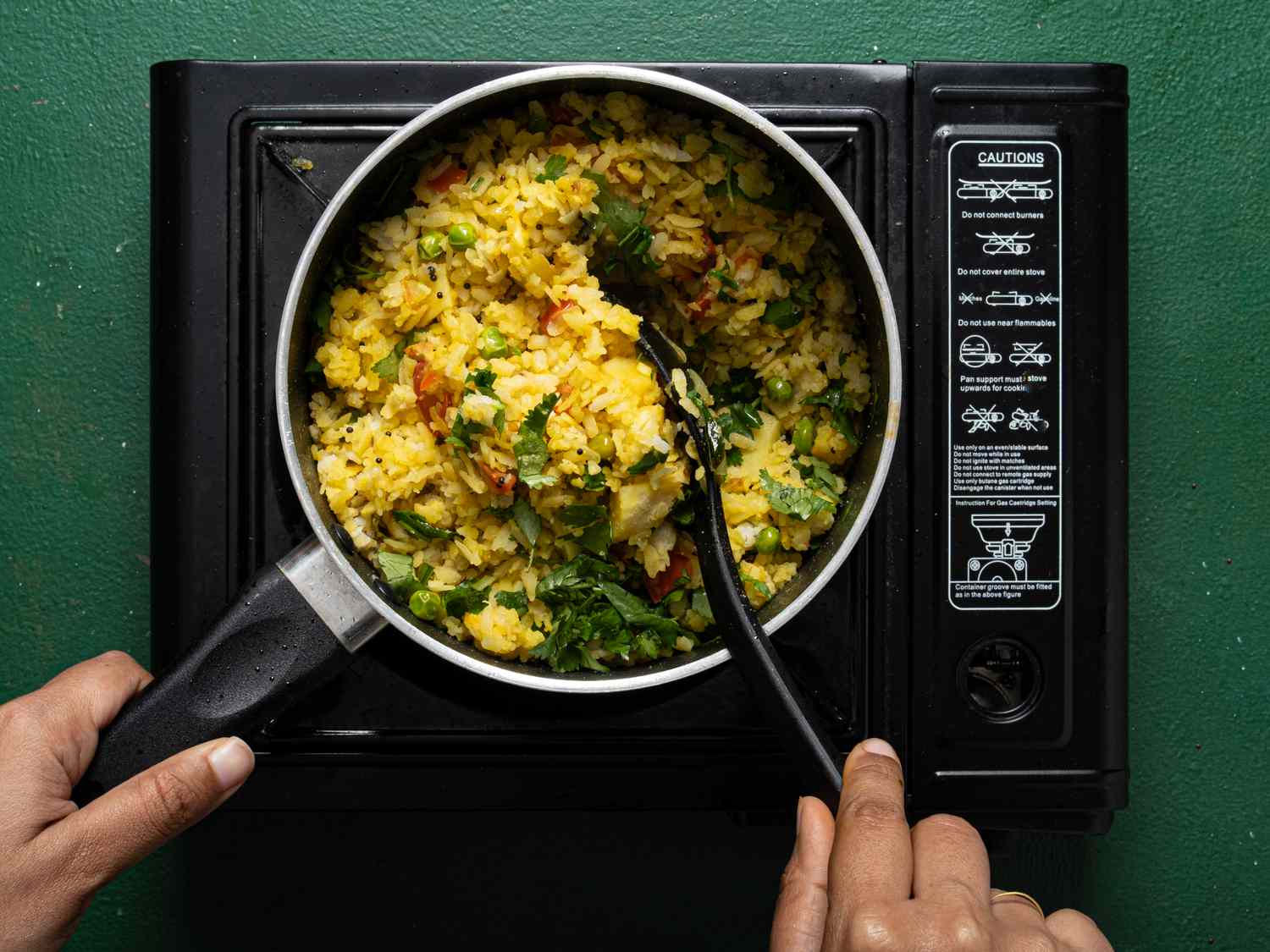 Overhead view of mixing pohe in pot