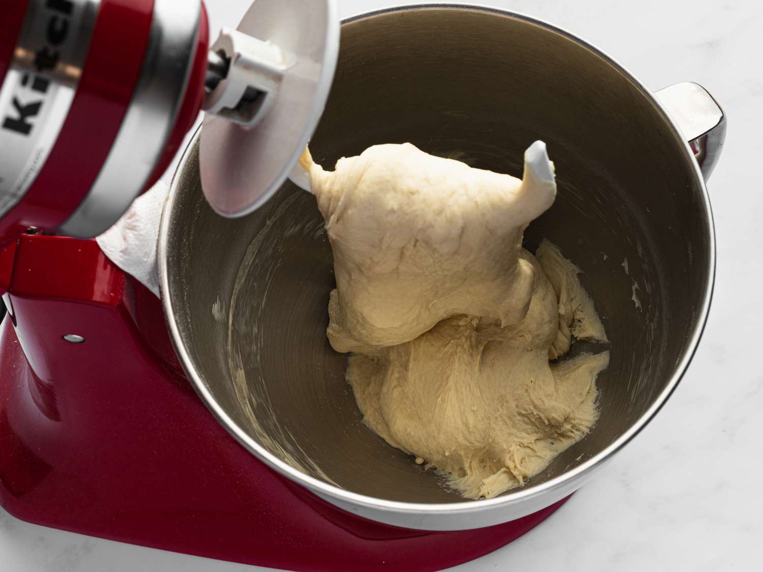 Overhead view of dough in a mixing bowl 