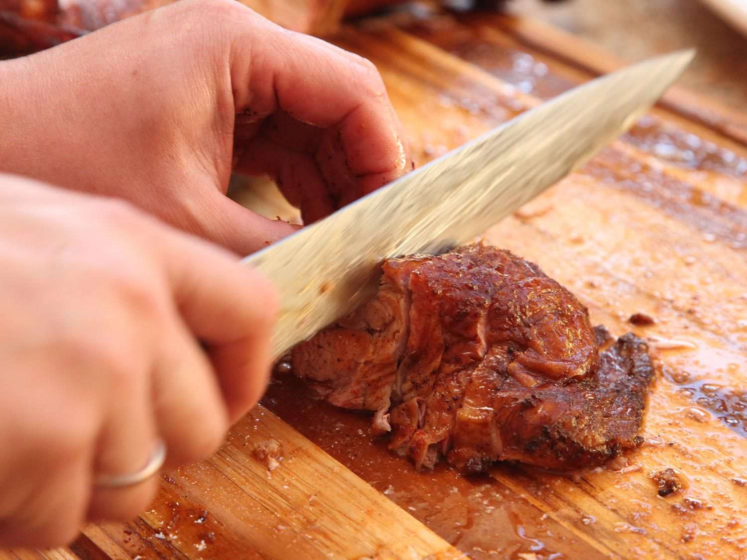 Slicing smoked turkey thigh meat.