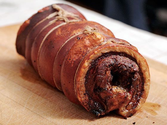 Finished porchetta with crispy, blistered skin