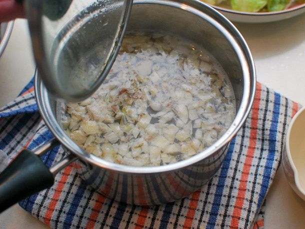 A pot of garlicky broth for pouring over braised greens.